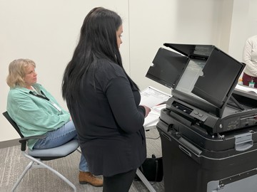 Election workers test a ballot tabulator